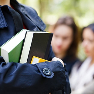 student holding books