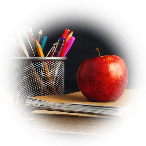 Apple and pencils on a teachers desk.